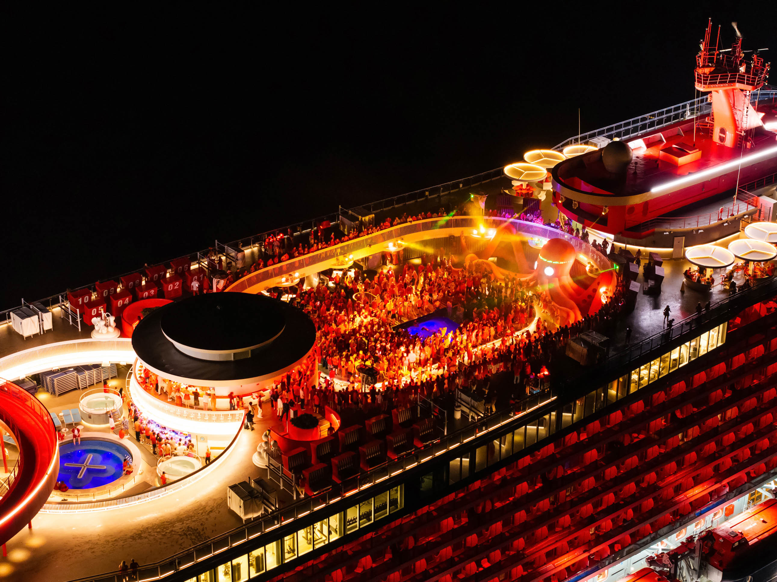 Virgin Voyages ship deck party at night
